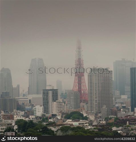 Buildings in a city with Tokyo Tower in the background, Tokyo, Japan