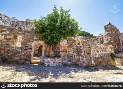Buildings in the fortress on the island of Spinalonga at the Gulf of Elounda, Crete, Greece. Here were isolated lepers, humans with Hansen’s disease.. Buildings in the fortress on the island of Spinalonga at the Gulf of Elounda, Crete, Greece.