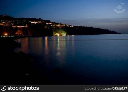 Buildings lit up at the waterfront, Bay of Naples, Sorrento, Sorrentine Peninsula, Naples Province, Campania, Italy