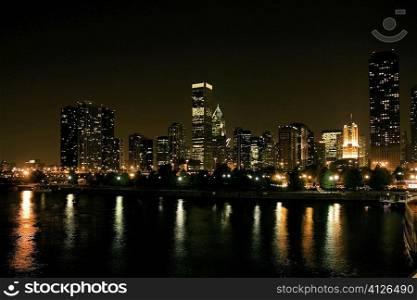 Buildings on a waterfront at night, Chicago, Illinois, USA