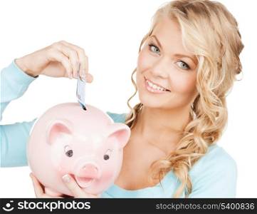 buisness, banking and savings concept - happy businesswoman puts cash money into big piggy bank