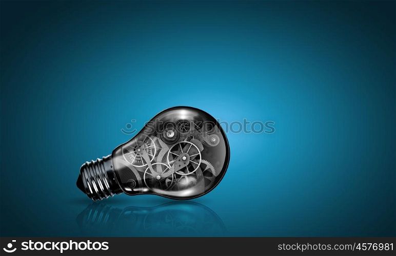 Bulb with gears. Conceptual image of light bulb with cogwheels inside