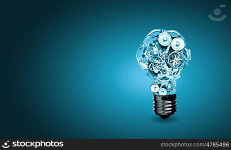 Bulb with gears. Conceptual image of light bulb with cogwheels inside