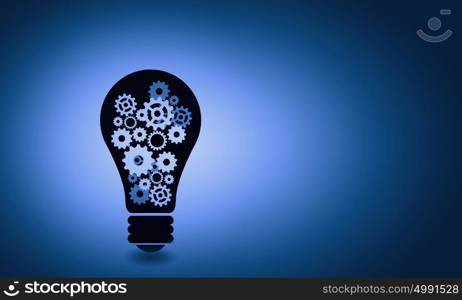 Bulb with gears. Conceptual image of light bulb with cogwheels inside