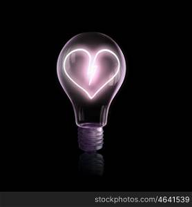 Bulb with heart. Glass light bulb with heart sign on black bakground