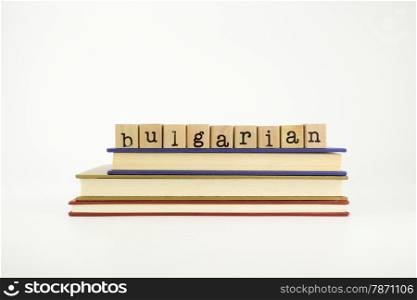 bulgarian word on wood stamps stack on books, language and conversation concept