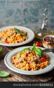 bulgur with chicken hearts and vegetables. Delicious healthy dish on dark background. Bulgur pilaf. Bulgur with chicken hearts