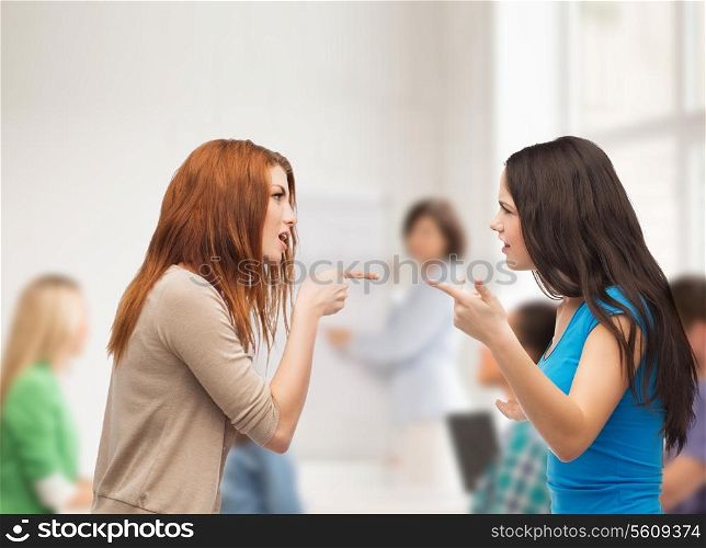 bullying, education, friendship and people concept - two teenagers having a fight at school