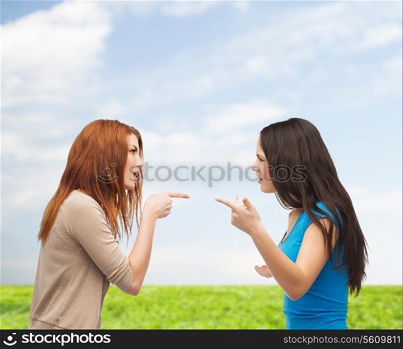 bullying, friendship and people concept - two teenagers having a fight