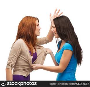 bullying, friendship and people concept - two teenagers having a fight and getting physical