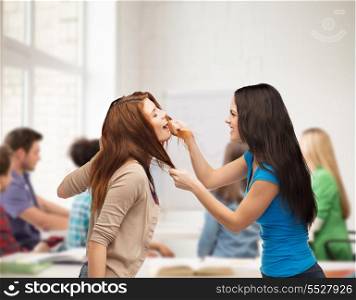 bullying, school, education, friendship and people concept - two teenagers having a fight and getting physical