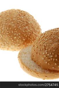 bun for sandwich cut . A bakery product strewed by grains