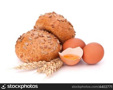 Bun with seeds and broken egg isolated on white background