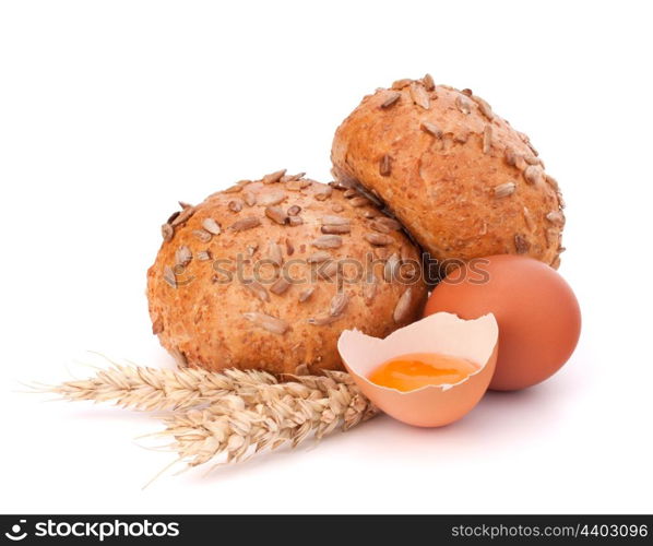 Bun with seeds and broken egg isolated on white background