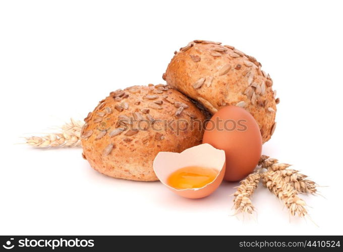 Bun with seeds and broken egg isolated on white background