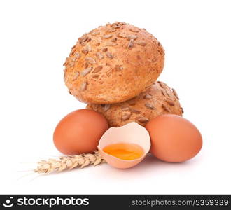 Bun with seeds and broken egg isolated on white background