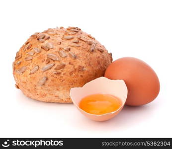 Bun with seeds and broken egg isolated on white background