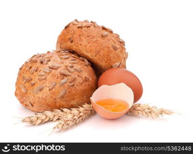 Bun with seeds and broken egg isolated on white background