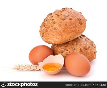 Bun with seeds and broken egg isolated on white background