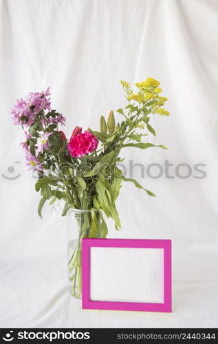 bunch flowers green stems vase near frame