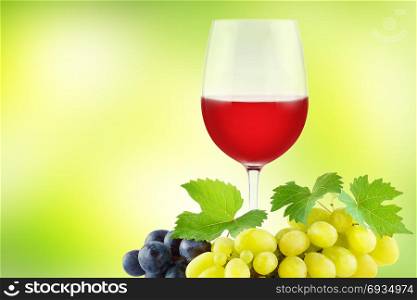 Bunch grapes with green fresh leaves and glass red wine on green background. Copy space