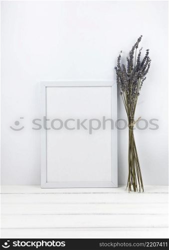bunch lavender flowers with empty frame wooden desk