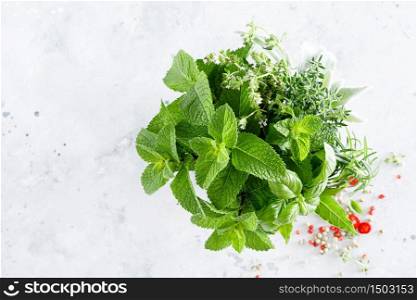 Bunch of aromatic herbs in mortar on kitchen table