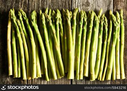 Bunch of asparagus over rustic wooden background