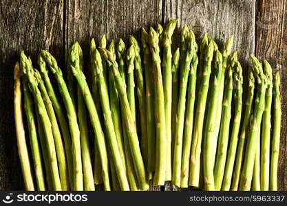 Bunch of asparagus over rustic wooden background