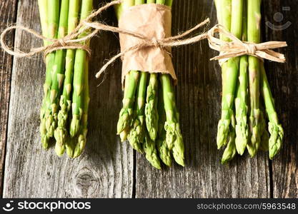 Bunch of asparagus over rustic wooden background