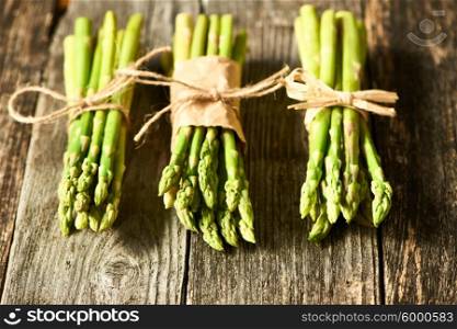 Bunch of asparagus over rustic wooden background