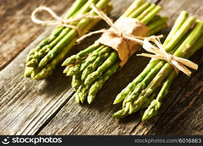 Bunch of asparagus over rustic wooden background