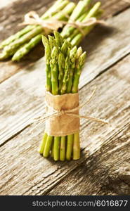 Bunch of asparagus over rustic wooden background