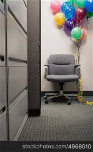 Bunch of balloons tied to office chair