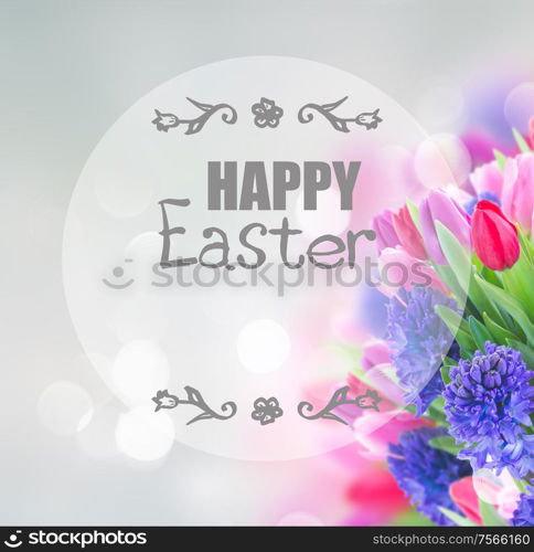 bunch of blue hyacinth and tulips bunch on blue background with happy Easter greeting. bouquet of blue hyacinth and tulips