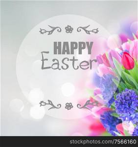 bunch of blue hyacinth and tulips bunch on blue background with happy Easter greeting. bouquet of blue hyacinth and tulips