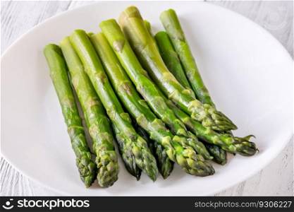 Bunch of boiled asparagus on white background