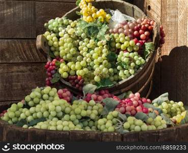Bunch of Colorful Grapes in Wodden Basket on Shelf For Sale