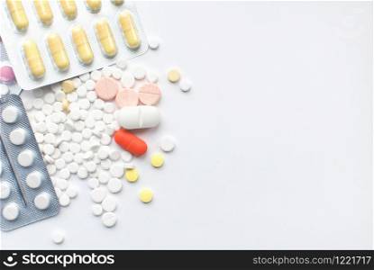 Bunch of colorful Medical Pills and tablets on white background. closeup. Healthcare and medicine. Medical pharmacy concept. Health day. Copyspace. Top view. Bunch of colorful Medical Pills on white background. closeup. Healthcare and medicine. Medical pharmacy concept. Health day