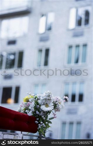 Bunch of flowers on a carriage with a building in the background