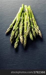 Bunch of fresh asparagus on slate background