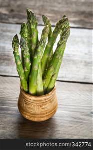 Bunch of fresh asparagus on the wooden background