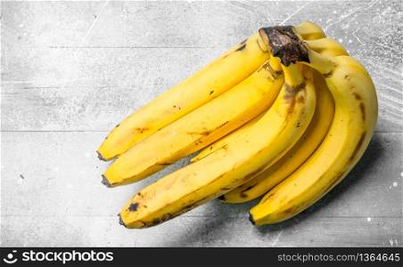 Bunch of fresh bananas. On white rustic background.. Bunch of fresh bananas.