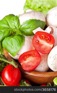 Bunch of fresh cherry tomato with basil and mushrooms, on white background
