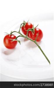bunch of fresh cherry tomatoes on white plate