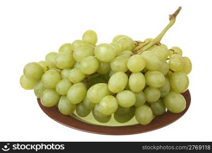 Bunch of fresh grapes on a plate over white background