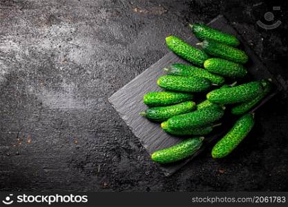 Bunch of fresh homemade cucumbers. On a black background. High quality photo. Bunch of fresh homemade cucumbers.