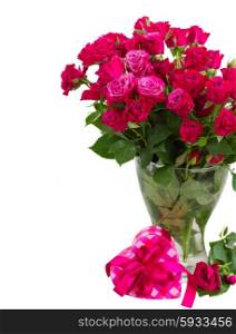 bunch of fresh mauve roses in glass vase with heart gift box isolated on white background