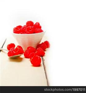 bunch of fresh raspberry on a bowl and white wood rustic table