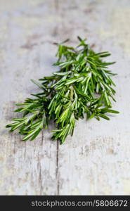 Bunch of fresh rosemary on a wooden background